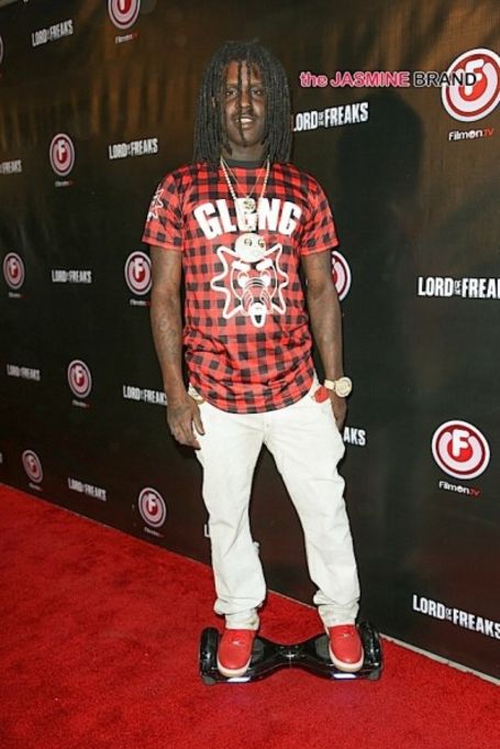 keef on the red caprt of lord of the freaks in a read shirt white pants and red shoes, standing on a hoverboard.  